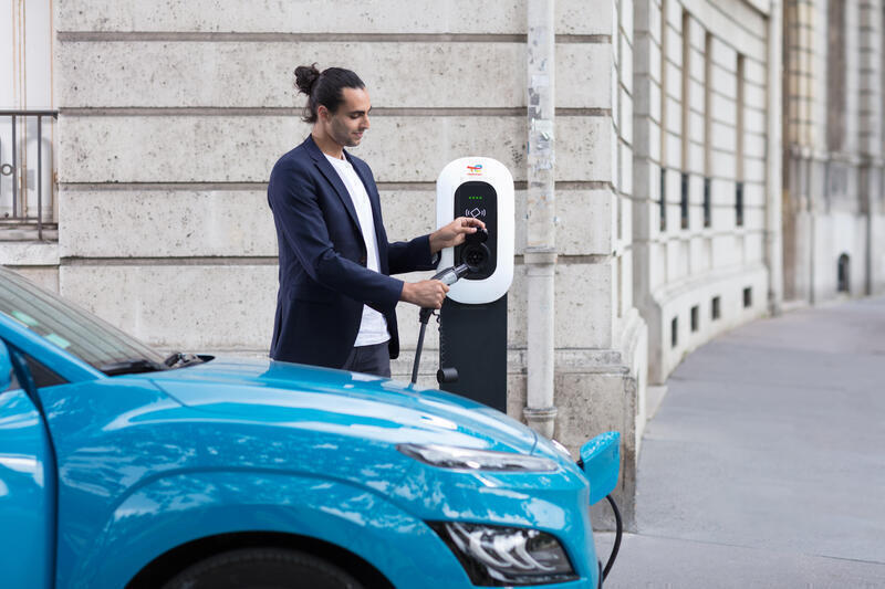 Image - Homme qui recharge sa voiture électrique avec une borne Charge+ TotalEnergies